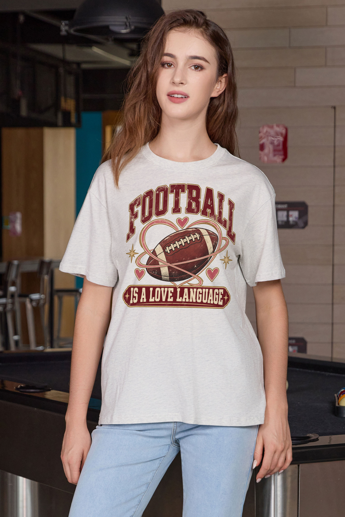 Football Is a Love Language Relaxed Tee in heather grey, front graphic on model, view 3
