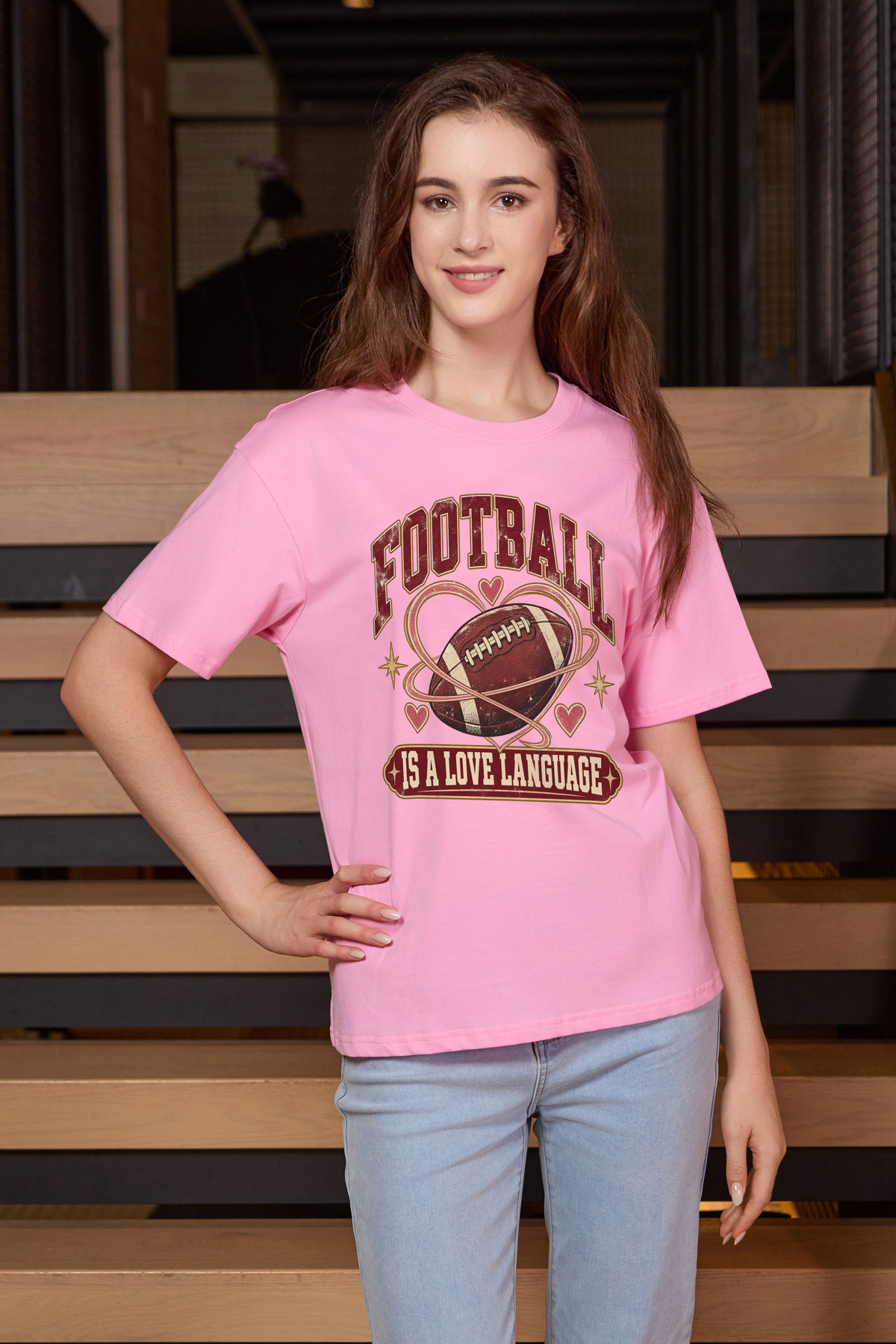 Football Is a Love Language Relaxed Tee in light pink, front graphic on model, view 1