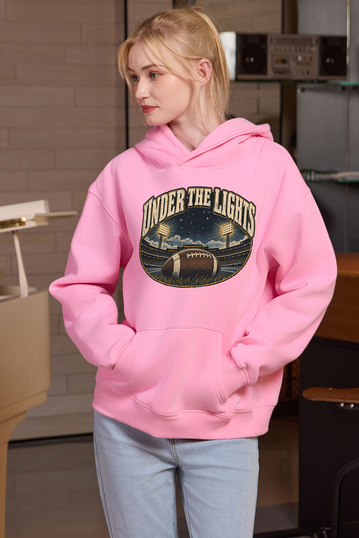 Under the Lights Hoodie in light pink, front graphic on model, view 1