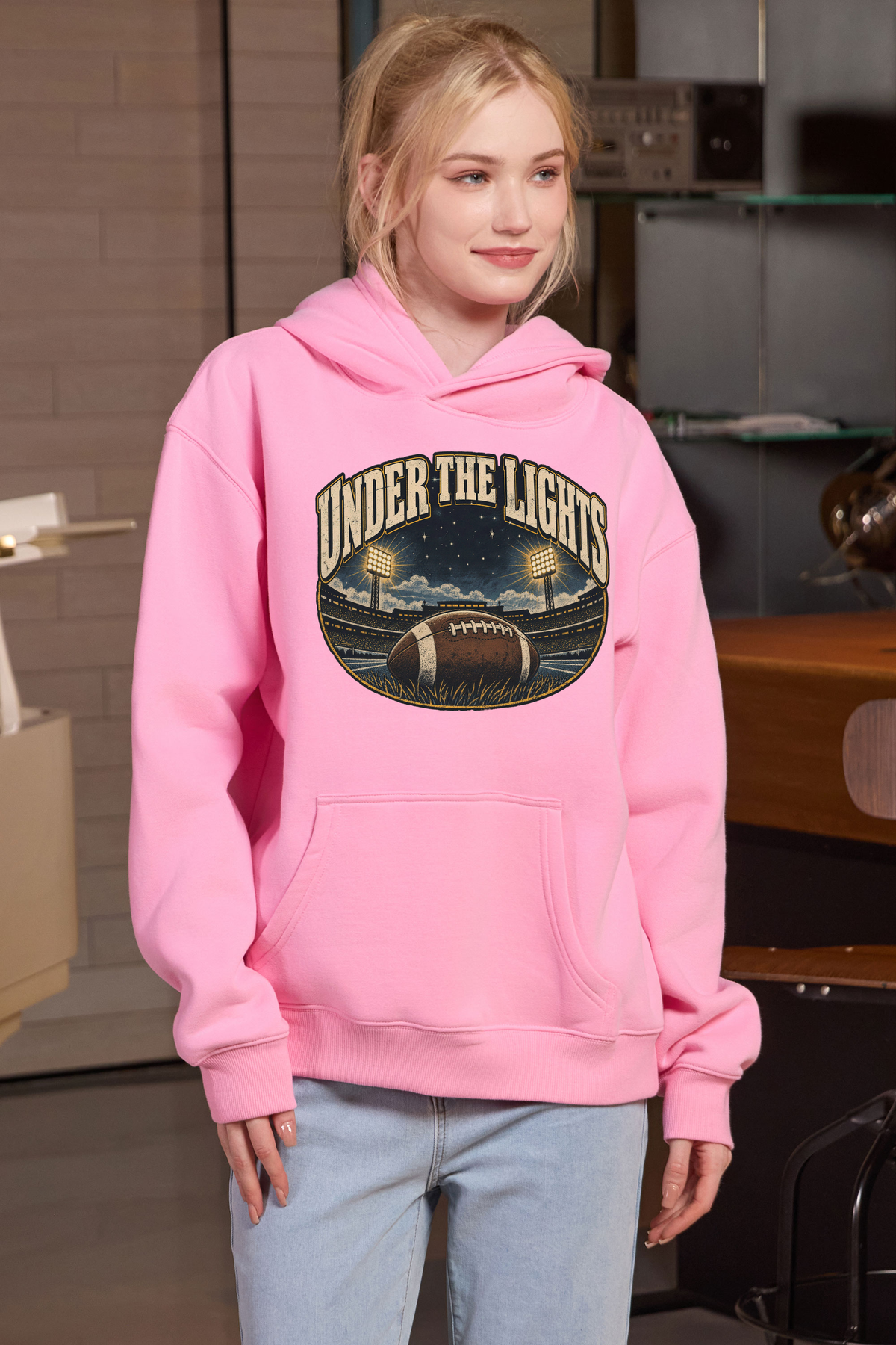 Under the Lights Hoodie in light pink, front graphic on model, view 2