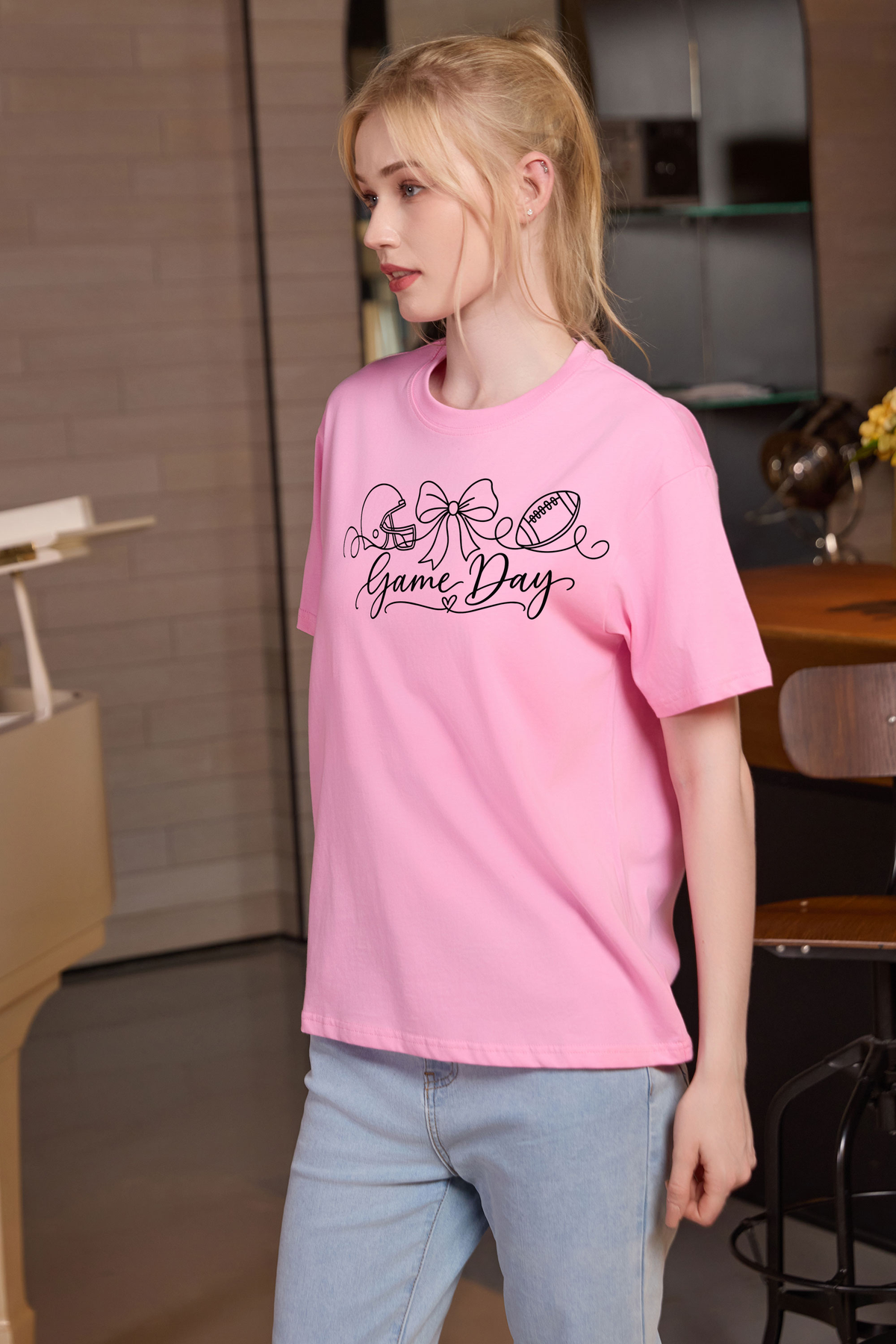 M001-G020 LIGHT-PINK F2 — Game Day String graphic on M001 light pink garment