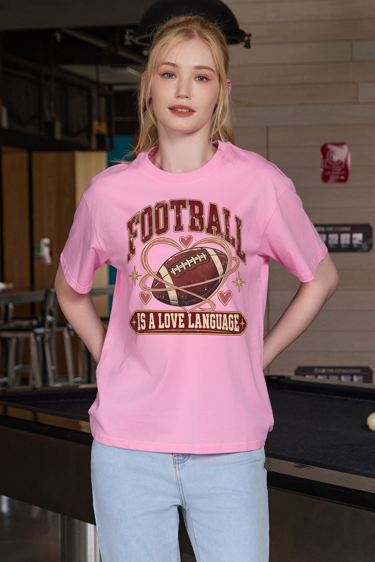 Football Is a Love Language Relaxed Tee in light pink, front graphic on model, view 3