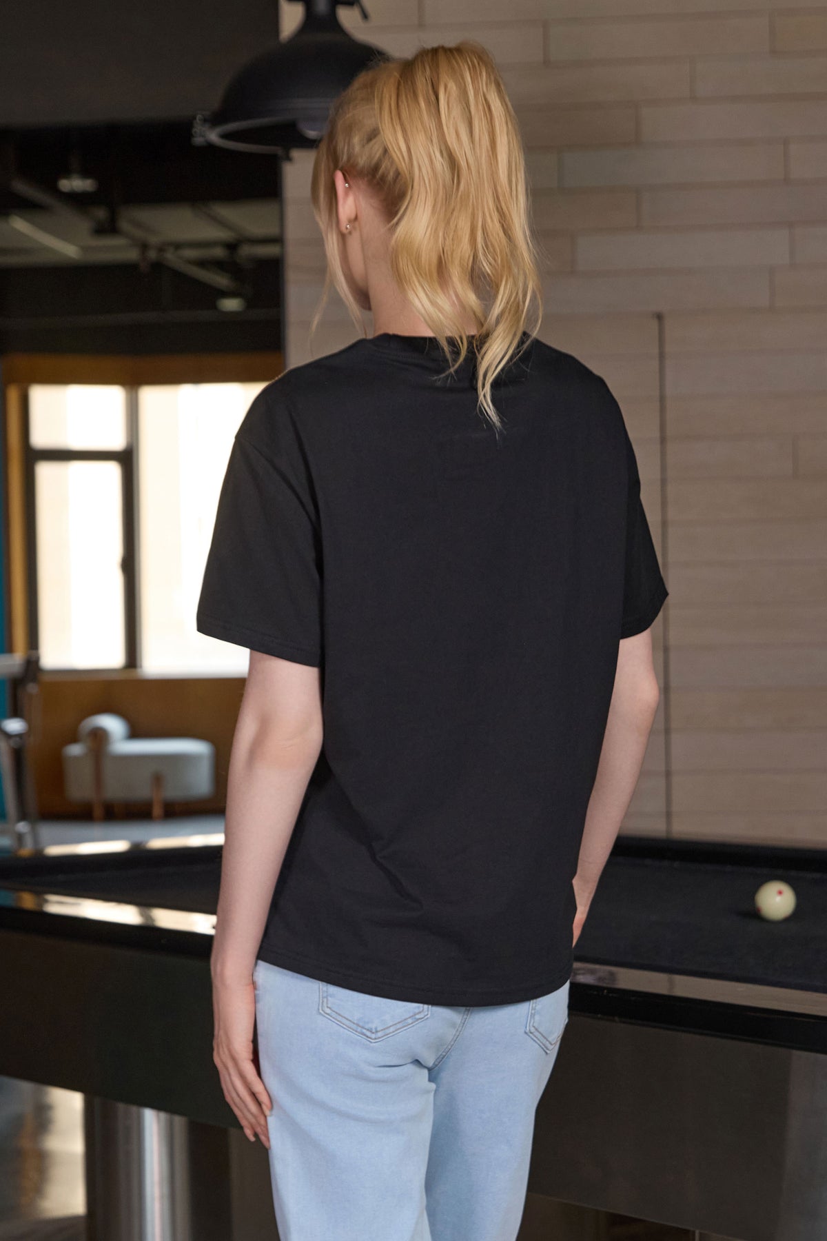 M001 tee in black — unprinted back view.