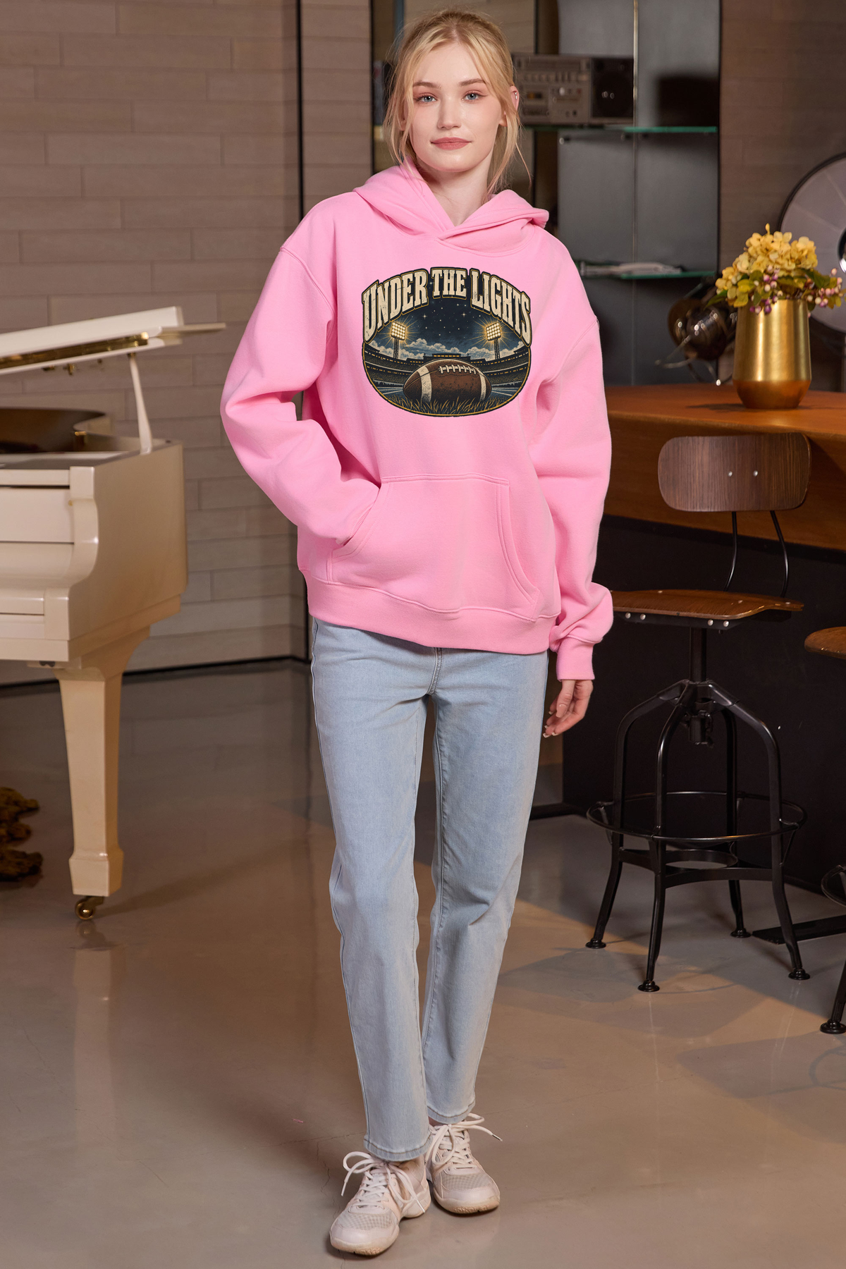 Under the Lights Hoodie in light pink, front graphic on model, view 3