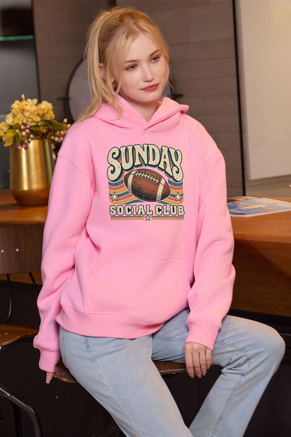 Sunday Social Club Hoodie in light pink, front graphic on model, view 1